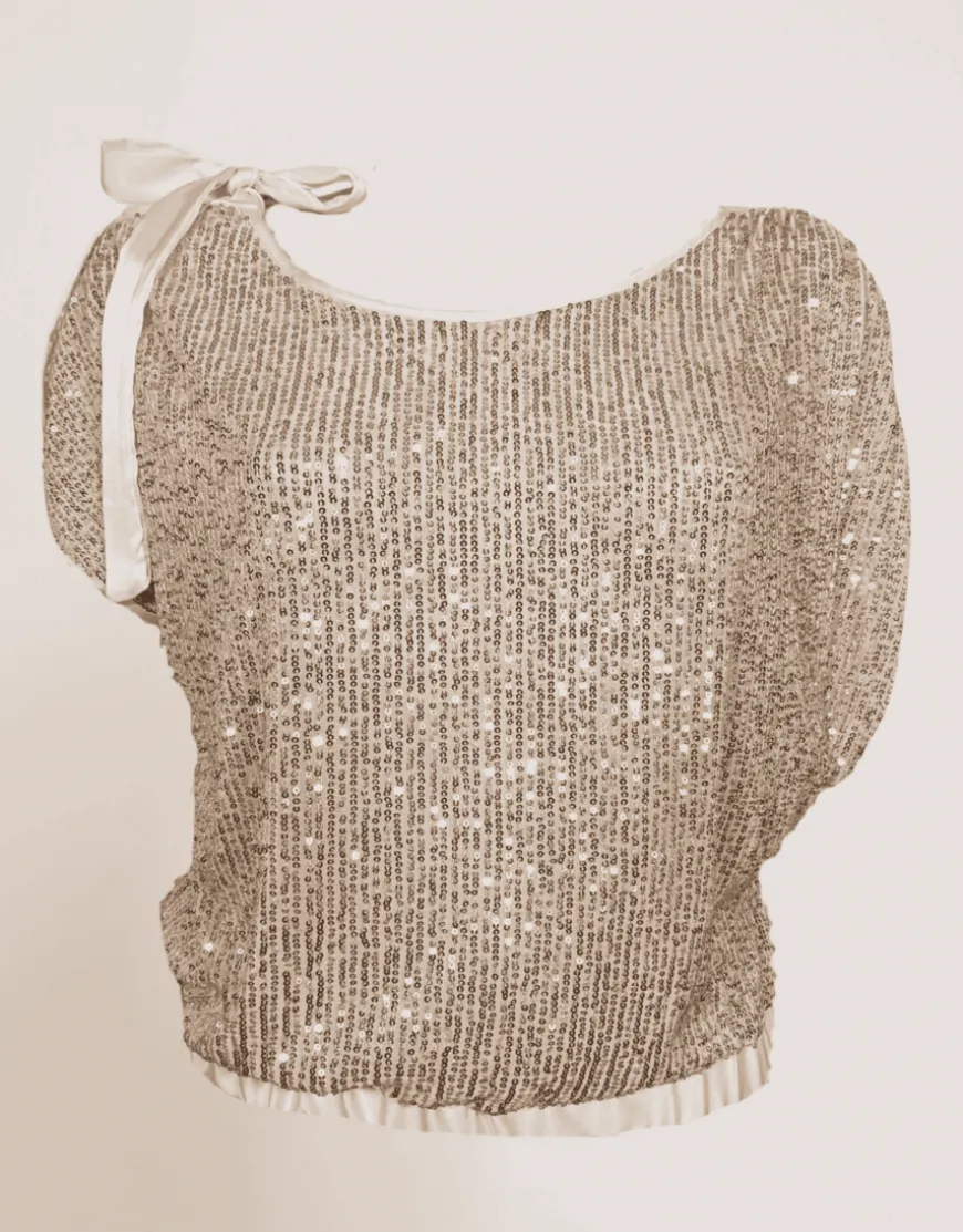 Casacca asimmetrica con paillettes e fiocco