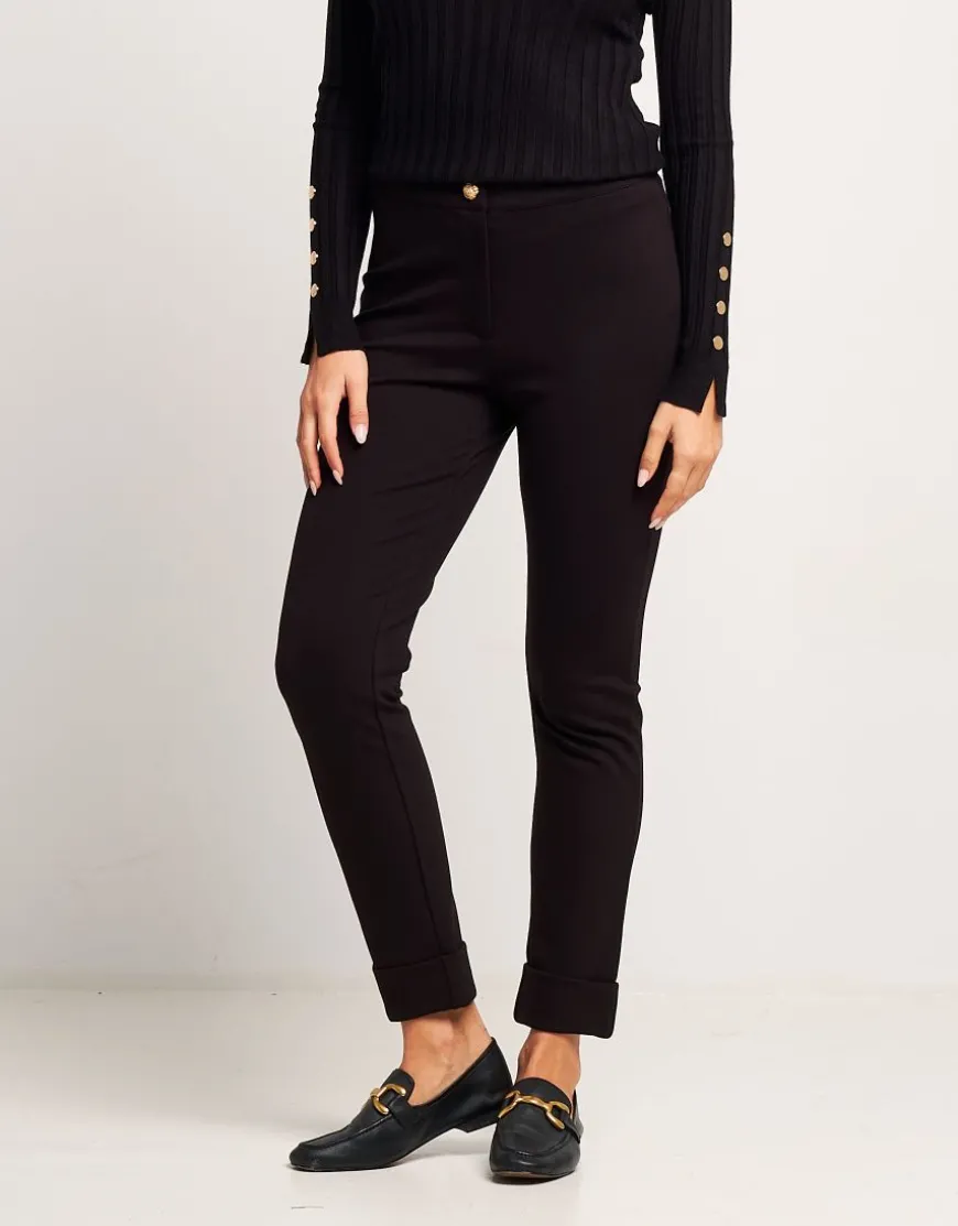 Pantalone con risvolto e bottone oro
