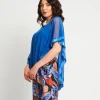 Poncho in rete con bordi in paillettes